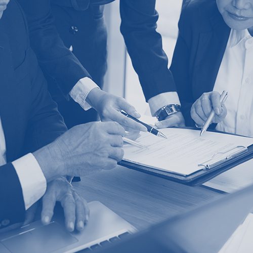 People reading contract terms at the meeting