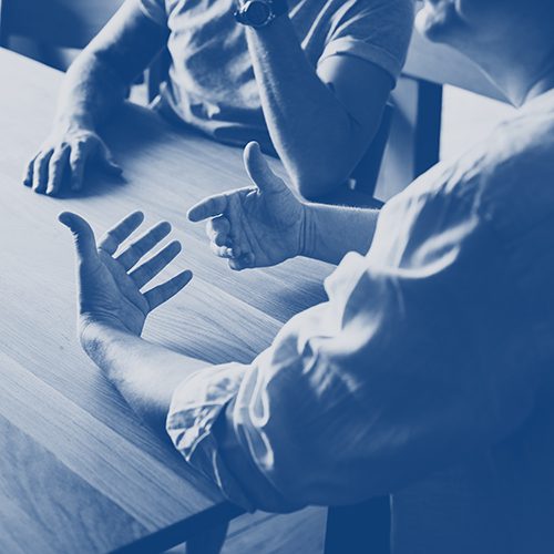 People talking at a desk